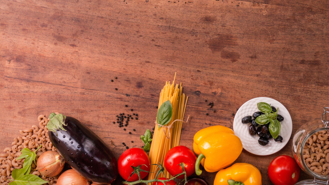 A wooden table with some vegetables on it