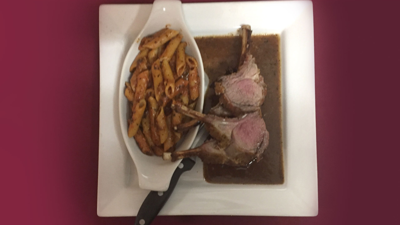 A plate of food with meat and sauce on it.