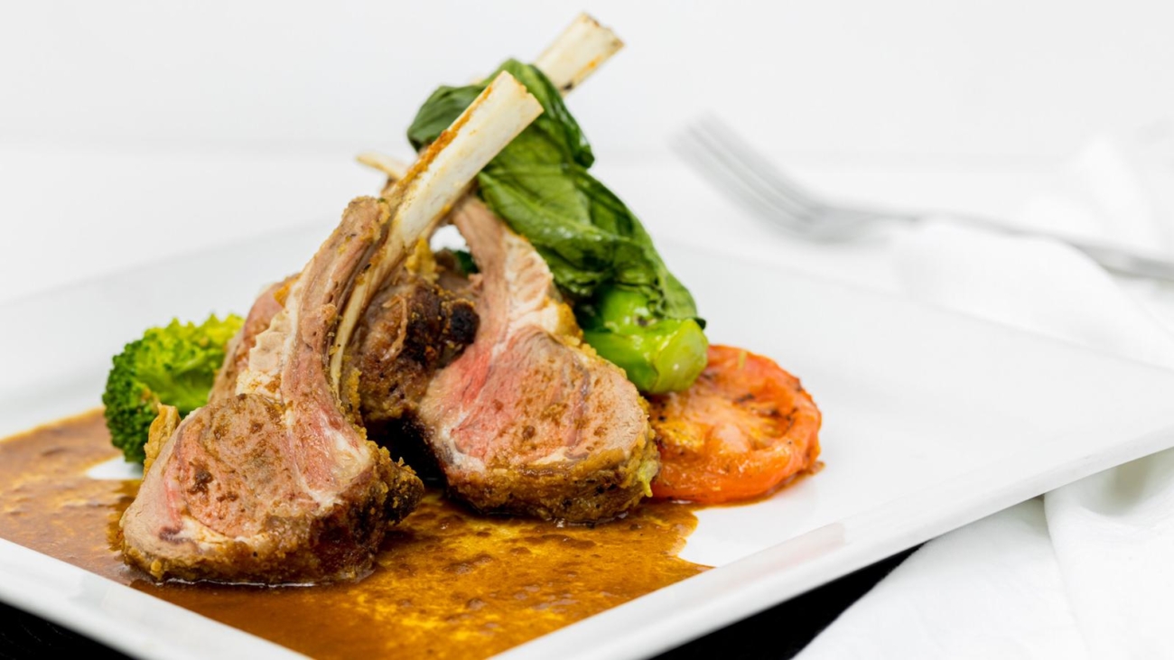 A plate of food with meat and vegetables on it.