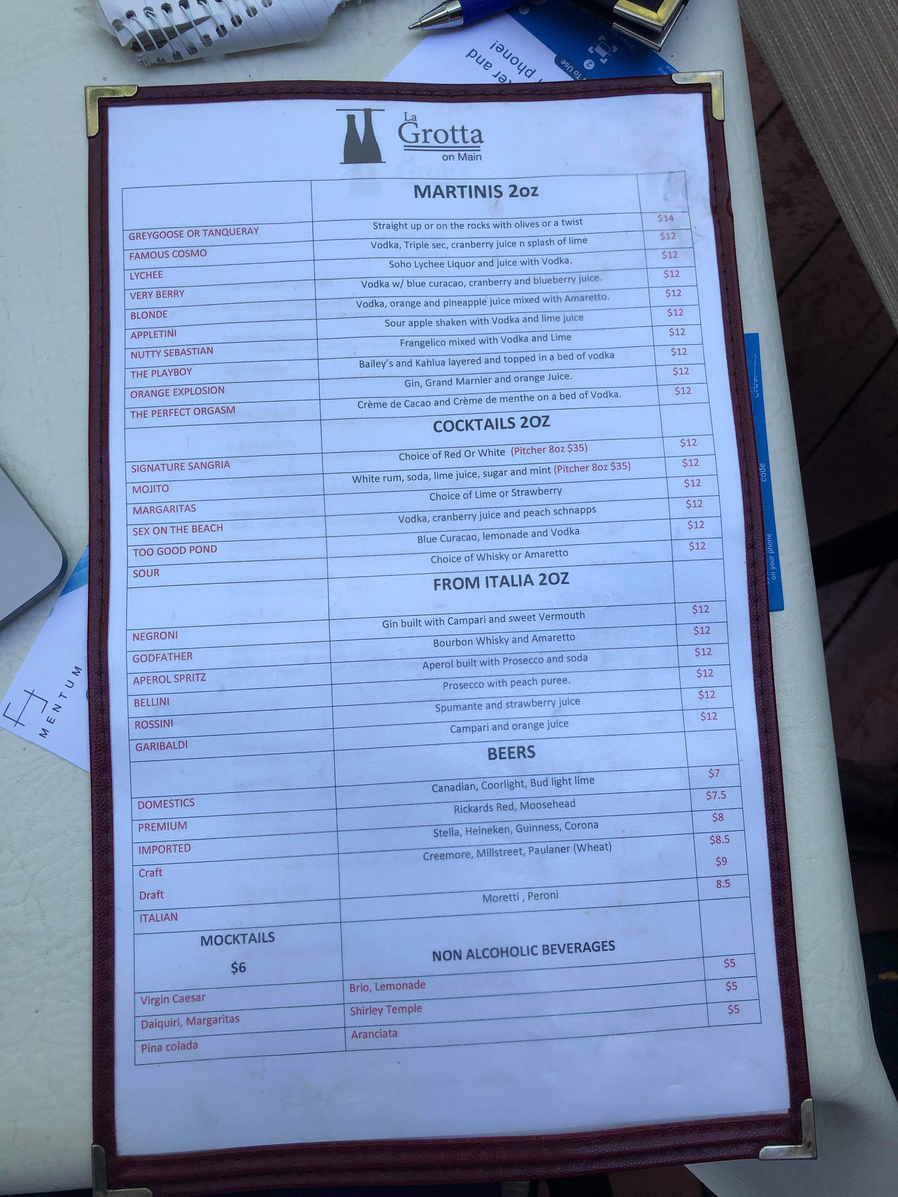 A menu of martinis and beers on the table.