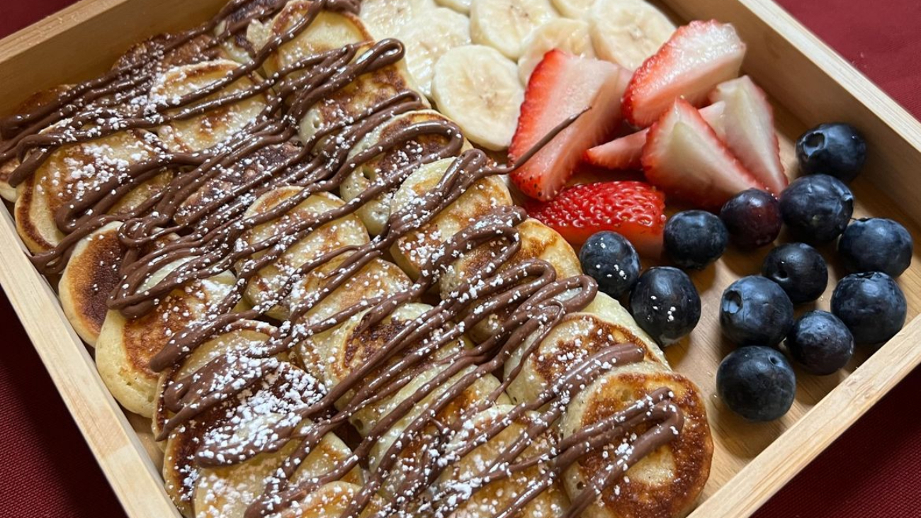 A wooden box filled with food on top of a table.