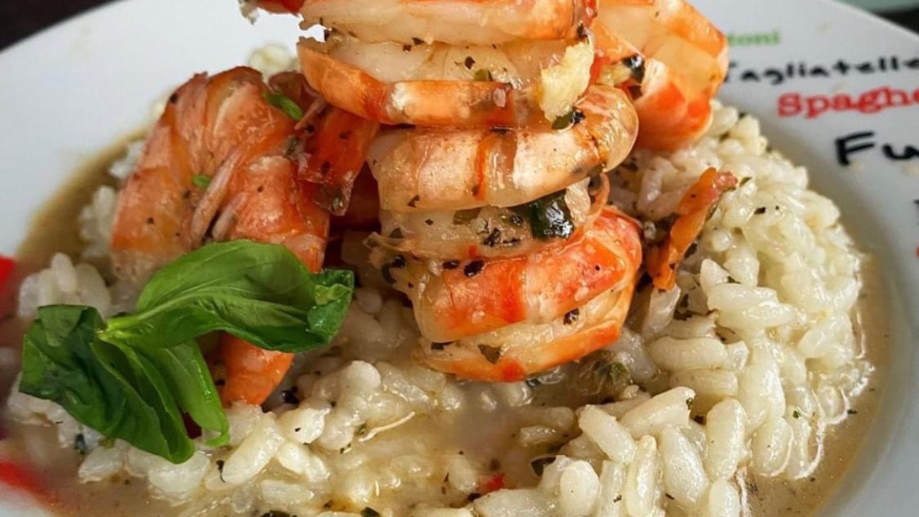 A plate of food with shrimp and rice on it.